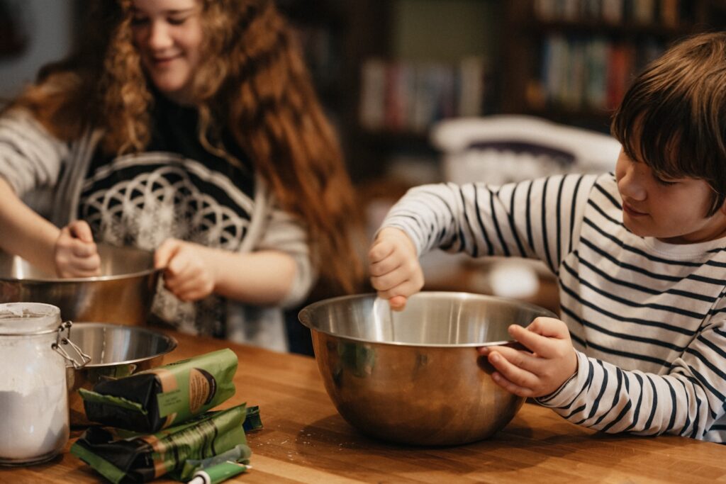 Kitty and Oz baking a Norman Castle cake for Ozzy's History homework.